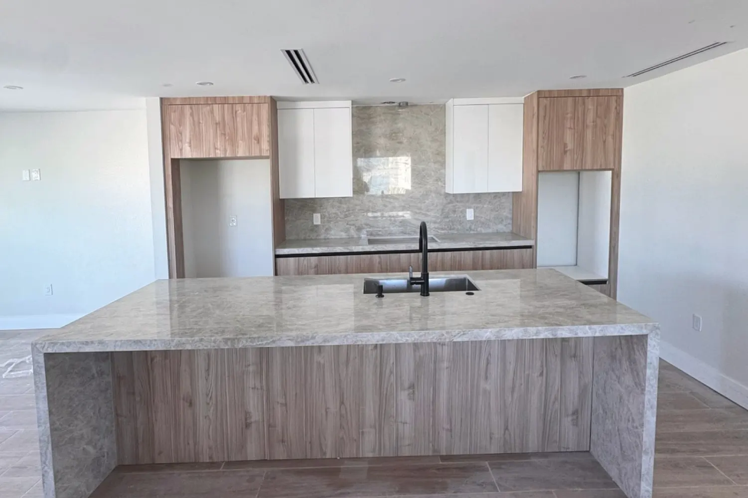 Kitchen 2: waterfall island in a gray surface with a wood front