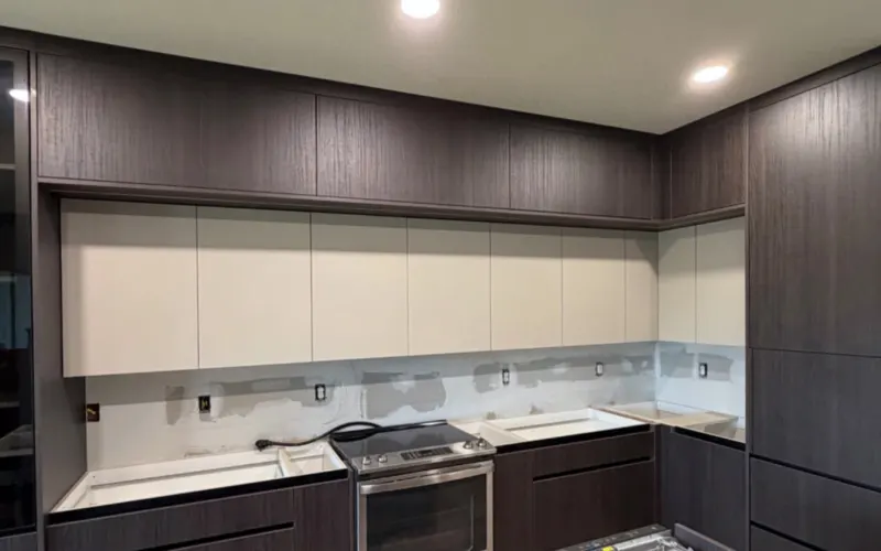 Kitchen 3: dark wood and white cabinets, being assembled