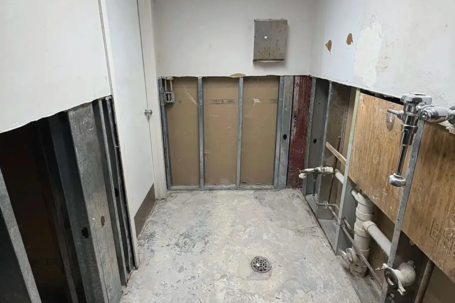During the work: the bathroom stripped down to the structure, with the plumbing exposed