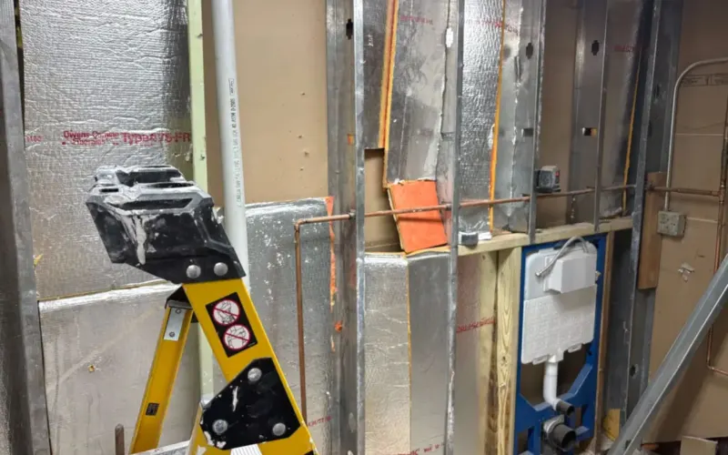 During the work: new plumbing and the in-wall carrier for the floating toilet