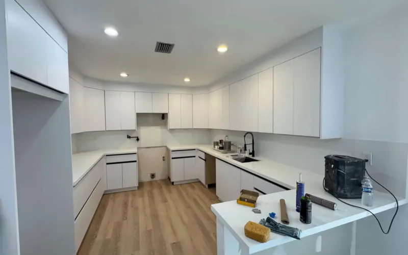 During the work: white cabinets, countertop and new floor in place